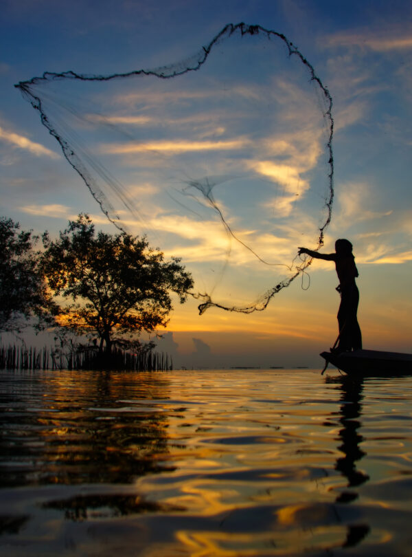 Silhouettes fisherman throwing fishing nets