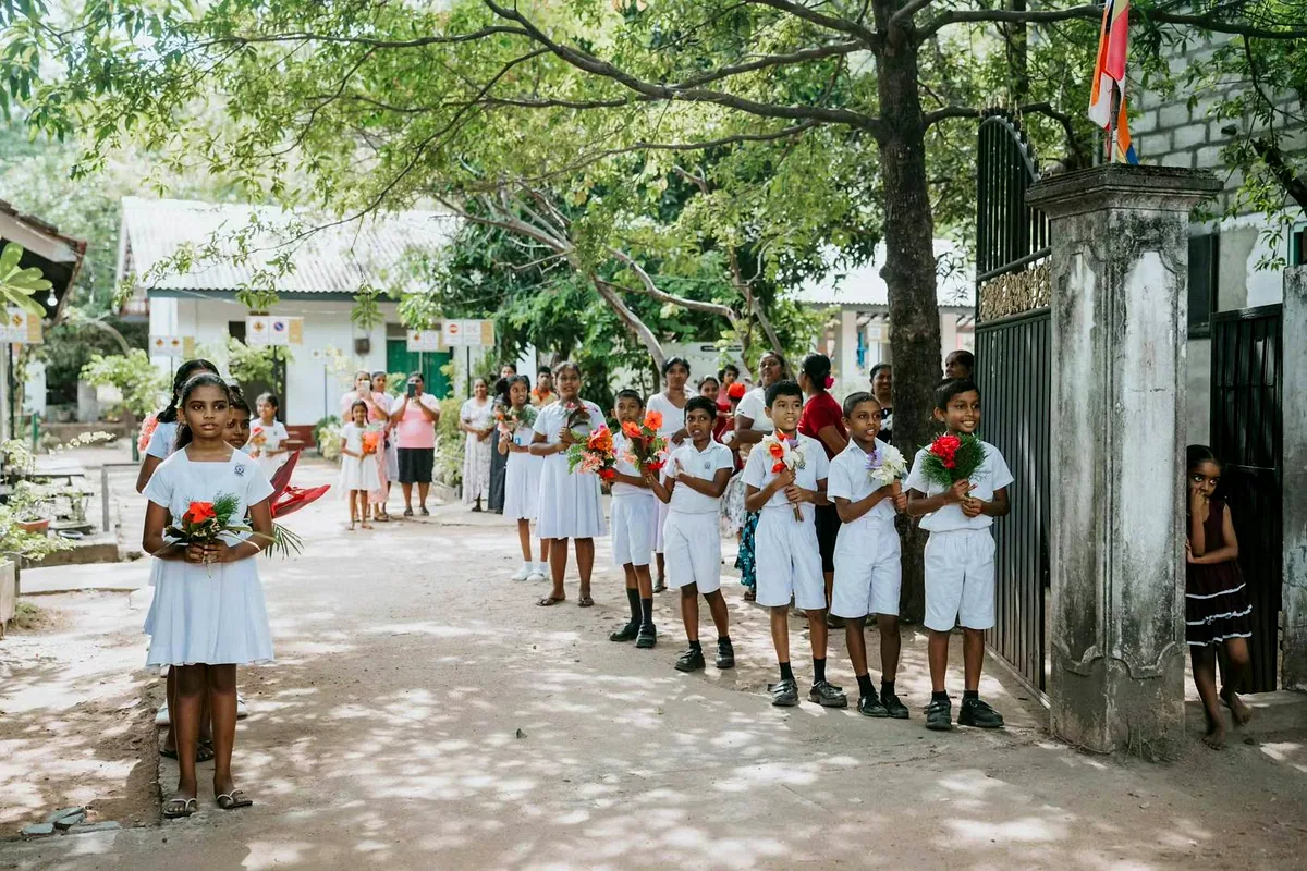 GCH school donation Minneriya Sri Lanka children with flowers