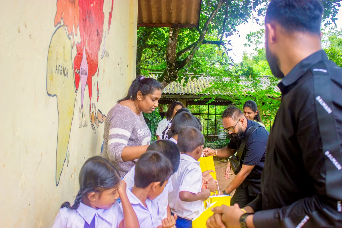 GCH team handing supplies Kandy school community support
