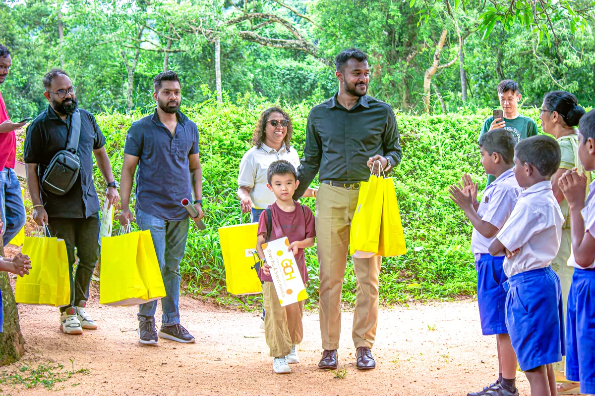 GCH team arriving with yellow gift bags for school donation Kandy Sri Lanka